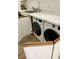 Modern laundry area featuring a washer and dryer discreetly tucked behind cabinet doors, and solid surface countertop at 3211 W Swann Ave # 408, Tampa, FL 33609