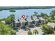 Aerial view of condos with parking, showcasing the lush landscaping and proximity to the water at 1111 N Bayshore Blvd # D6, Clearwater, FL 33759