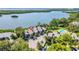 Aerial view of condos with a community pool, parking, and serene water views in a lush setting at 1111 N Bayshore Blvd # D6, Clearwater, FL 33759