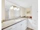 Bright bathroom featuring a large mirror, granite countertop, and ample storage space at 1111 N Bayshore Blvd # D6, Clearwater, FL 33759