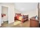 Bedroom with hardwood floors, a wooden bed frame, and access to the attached bathroom at 1111 N Bayshore Blvd # D6, Clearwater, FL 33759