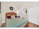 Comfortable bedroom featuring a wicker headboard, a ceiling fan, and closet with paneled doors at 1111 N Bayshore Blvd # D6, Clearwater, FL 33759