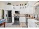 Bright kitchen featuring white cabinets, stainless steel appliances, and granite countertops at 1111 N Bayshore Blvd # D6, Clearwater, FL 33759