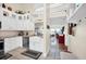 Bright kitchen featuring white cabinets, granite countertops, and an open view into the living area at 1111 N Bayshore Blvd # D6, Clearwater, FL 33759