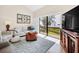 Bright living room showcasing water views through sliding glass doors, neutral furniture and decor at 1111 N Bayshore Blvd # D6, Clearwater, FL 33759