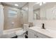 Updated bathroom with tile shower, tub, dark floors, and vanity, offering a modern and clean aesthetic at 3400 Dawson Ln, Punta Gorda, FL 33950