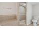 Tiled bathroom with a walk-in shower, built-in bench, and modern fixtures, offering a comfortable and functional space at 3400 Dawson Ln, Punta Gorda, FL 33950