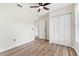 Bedroom featuring wood-look floors, bright white walls, and a closet with bi-fold doors at 3400 Dawson Ln, Punta Gorda, FL 33950