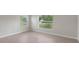 Bright bedroom with tile floor and a window overlooking the front yard at 3400 Dawson Ln, Punta Gorda, FL 33950
