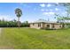 Single-story home with metal roof, neutral exterior, and large manicured front lawn at 3400 Dawson Ln, Punta Gorda, FL 33950