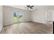 Bright living room featuring new wood-look flooring and sliding glass doors that provide lots of natural light at 3400 Dawson Ln, Punta Gorda, FL 33950