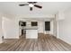 Open living room showcasing new floors, modern fixtures, and a seamless transition into the updated kitchen at 3400 Dawson Ln, Punta Gorda, FL 33950