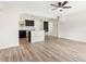 Open living room and kitchen space, complete with new wood-look floors and plenty of natural light at 3400 Dawson Ln, Punta Gorda, FL 33950
