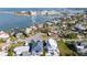 An aerial view of a home located on a charming cul-de-sac with lush landscaping and mature trees at 520 Baywood S Dr, Dunedin, FL 34698
