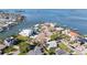 Scenic aerial view of coastal home near a bay inlet, showcasing lush landscaping and neighborhood at 520 Baywood S Dr, Dunedin, FL 34698