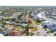 Aerial view showcasing a charming coastal home with lush surroundings, close to the community waterway at 520 Baywood S Dr, Dunedin, FL 34698