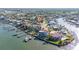 Breathtaking aerial shot showcasing a waterfront home near the bay, surrounded by lush tropical landscaping at 520 Baywood S Dr, Dunedin, FL 34698