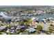 Aerial view of home near waterway showing neighboring homes and manicured lawns in a Florida neighborhood at 520 Baywood S Dr, Dunedin, FL 34698