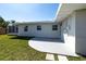 Home's back exterior showcases a concrete patio area, and yard space at 520 Baywood S Dr, Dunedin, FL 34698