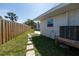 Well-maintained backyard with stepping stones, privacy fence, and room for outdoor activities at 520 Baywood S Dr, Dunedin, FL 34698