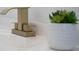 Close-up of bathroom vanity featuring a modern, gold faucet and white countertop at 520 Baywood S Dr, Dunedin, FL 34698