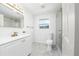 Bright bathroom features modern fixtures, a glass-enclosed shower, and marble patterned tile floor at 520 Baywood S Dr, Dunedin, FL 34698
