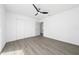 Bright, spacious bedroom featuring gray flooring, a closet, and a modern ceiling fan at 520 Baywood S Dr, Dunedin, FL 34698