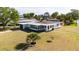 Landscaped home with a well-manicured lawn and an attached garage at 520 Baywood S Dr, Dunedin, FL 34698