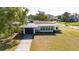Beautifully landscaped home with a well-manicured lawn and an attached garage at 520 Baywood S Dr, Dunedin, FL 34698