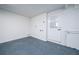 Spacious garage with durable epoxy floor, and a white door leading to the home's interior at 520 Baywood S Dr, Dunedin, FL 34698