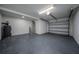 Clean, epoxy-floored garage featuring ample space for parking and storage, plus water heater at 520 Baywood S Dr, Dunedin, FL 34698