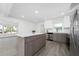 Kitchen with gray accent island, stainless appliances, open floorplan at 520 Baywood S Dr, Dunedin, FL 34698