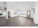 Open concept living room and entryway features updated fixtures and vinyl wood floors at 520 Baywood S Dr, Dunedin, FL 34698