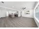 Spacious living room with hardwood floors, an open kitchen, and large windows at 520 Baywood S Dr, Dunedin, FL 34698