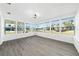 Sunroom with vinyl wood floors and bright natural light from surrounding windows at 520 Baywood S Dr, Dunedin, FL 34698