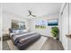 Bedroom with a ceiling fan, neutral walls, and a plush bed with blue and gray bedding at 520 Baywood S Dr, Dunedin, FL 34698