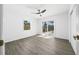 Bedroom with neutral paint, ample natural light from the slider, and wood-look flooring at 520 Baywood S Dr, Dunedin, FL 34698
