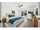 Sunlit bedroom featuring modern furniture and a sliding door to an enclosed outdoor space at 520 Baywood S Dr, Dunedin, FL 34698