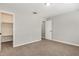 Neutral bedroom featuring plush carpet and an open closet for storage at 13516 Copper Head Dr, Riverview, FL 33569