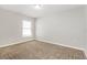 Neutral bedroom featuring plush carpet and a window with natural light at 13516 Copper Head Dr, Riverview, FL 33569