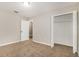 A neutral bedroom with an open closet and plush carpeting throughout at 13516 Copper Head Dr, Riverview, FL 33569