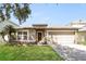 Charming single-story home featuring a well-manicured lawn, neutral paint, and an attached two-car garage at 13516 Copper Head Dr, Riverview, FL 33569