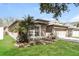 A cozy single-story house with a well-kept lawn and tasteful landscaping. The home has a two-car garage at 13516 Copper Head Dr, Riverview, FL 33569