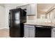 The kitchen area includes stone countertops, black appliances and gray cabinets at 13516 Copper Head Dr, Riverview, FL 33569