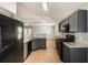 Bright, open kitchen with stone counters, stainless steel appliances, and sight lines into the dining area at 13516 Copper Head Dr, Riverview, FL 33569