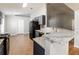 Well-lit kitchen with stone countertops, gray cabinets, and black appliances, providing a modern look at 13516 Copper Head Dr, Riverview, FL 33569