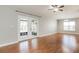 Bright living room featuring wood floors, modern ceiling fan and french doors with backyard view at 13516 Copper Head Dr, Riverview, FL 33569