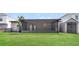 Back patio with screened porch, shed, and well-maintained backyard lawn at 13516 Copper Head Dr, Riverview, FL 33569