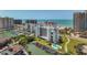 Aerial view of a resort and beach with boat docks, slips, and a swimming pool at 1581 Gulf Blvd # 102N, Clearwater Beach, FL 33767