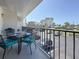 Outdoor dining on the balcony with seating and a view of the beach and the building at 1581 Gulf Blvd # 102N, Clearwater Beach, FL 33767